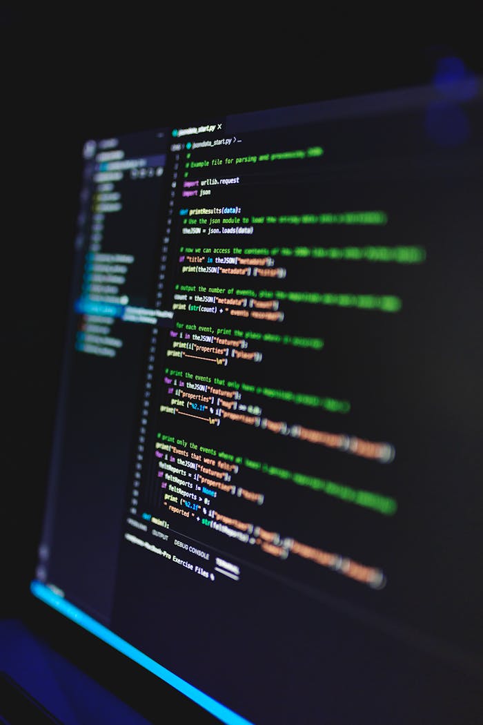 The Art of Drawing Readers In: Your attractive post title goes here Vertical shot of colorful programming code on a screen in a dark room, highlighting technology work.